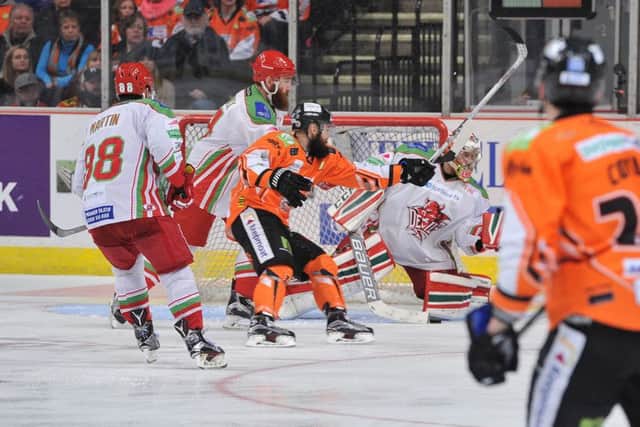 Jason Hewitt gets enough stick on the puck to steer it past Ben Bowns to level for Sheffield Steelers against Cardiff Devils. Picture: Dean Woolley.