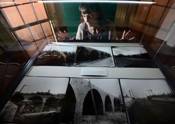 Doncaster Museums' Nicola Fox with a selection of photographs of the North Bridge under construction (1909 -1910). The pictures make up part of an exhibition, at Cusworth Hall, of the work of Doncaster photographer Luke Bagshaw from 1894-1944. Picture Scott Merrylees