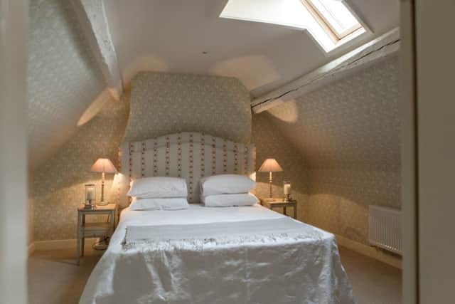 The five bedroom apartment is set over three floors and this bedroom is on the top floor complete with new rooflight window and historic beams
