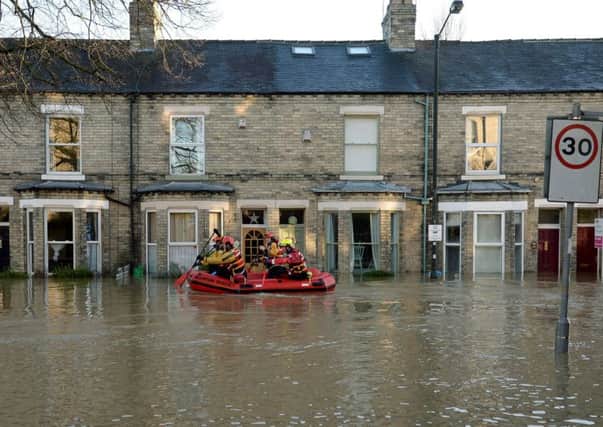 Members of a Mountain Rescue team paddle along Huntington Road in York, after the River Foss and Ouse burst their banks at Christmas.