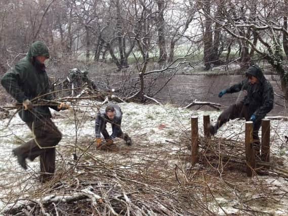 Volunteers from the Yorkshire Dales Rivers Trust at work on a river management project on a cold winter's day.