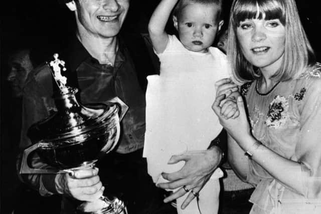 World Snooker Champion, Alex Higgins is saluted by his baby daughter Lauren with his wife Lynne, after a nail-biting battle against six-times champion Ray Reardon at Sheffield's Crucible Theatre in 1982. A new BBC film now charts the changing face of snooker in the 1980s. (Picture: PA Archive)