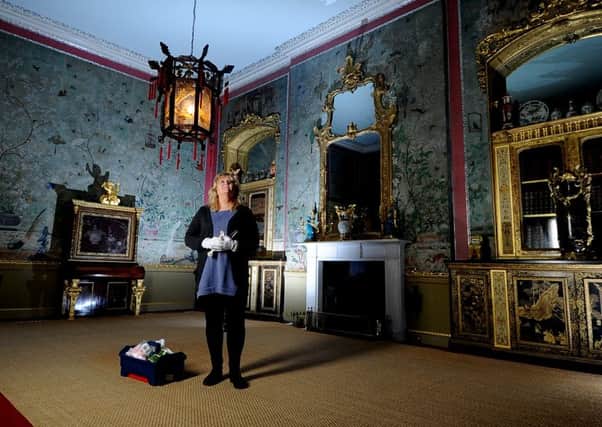 Lynne Crispin, visitor assistant at Temple Newsam House, Leeds, in the Chinese Drawing Room which has undergone a full clean and inspection of the hand-painted wallpaper covered in colourful, exotic birds a gift from the then Prince of Wales, a close friend who had visited Lady Hertford in 1807. Twenty years later, when she came to put it on the walls, Lady Hertford decided is needed to be more lively, and pasted on birds cut out from her copy of Audubons famous book The Birds of America.