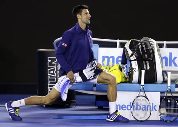 WE CAN WORK IT OUT: Novak Djokovic of Serbia stretches while he waits for his opponent Kei Nishikori to return to the court.