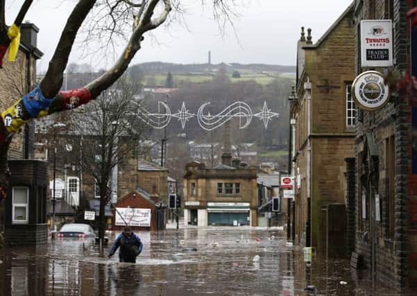 A man wades through flood waters at Hebden Bridge. Peter Byrne/PA Wire