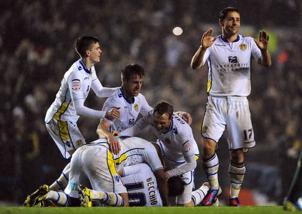 Luciano Becchio is mobbed by his team-mates after scoring the opening goal for Leeds United against Chelsea in the League Cup in 2012.
