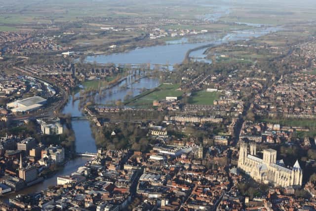 The River Ouse bursts its banks in the distance beyond York Minster after the city was hit by flooding in December 2015