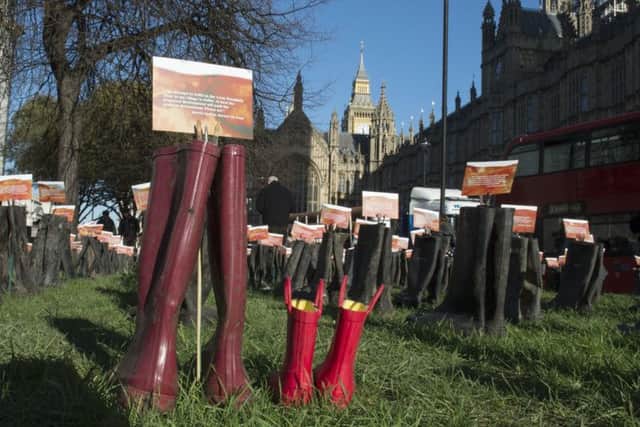 Greenpeace campaigners and people from flood-hit areas installed an artwork outside the Houses of Parliament in London, featuring 500 pairs of wellington boots, which each carry a message from those affected by the recent flooding.