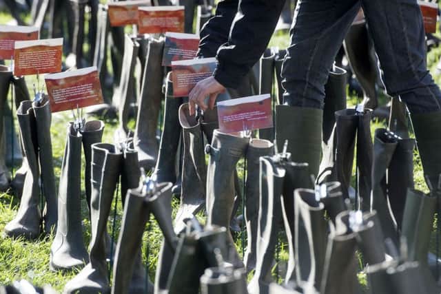 Greenpeace campaigners and people from flood-hit areas installed an artwork outside the Houses of Parliament in London, featuring 500 pairs of wellington boots, which each carry a message from those affected by the recent flooding.
