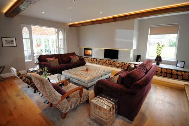 The sitting room, which Simon designed . The chimney breast and alcove were boxed in and wrapped in grey granite with a matching log storage bench and a wood burning fire.
