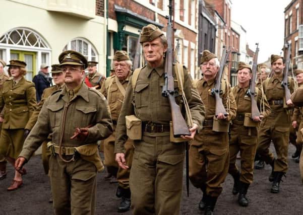 The Walmington-on-Sea Home Guard, led by Captain Mainwaring (Toby Jones) march through Bridlington Old Town during filming. Photo: Universal.