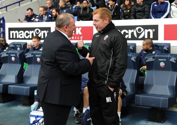 United's head coach Steve Evans chats to Bolton manager Neil Lennon.