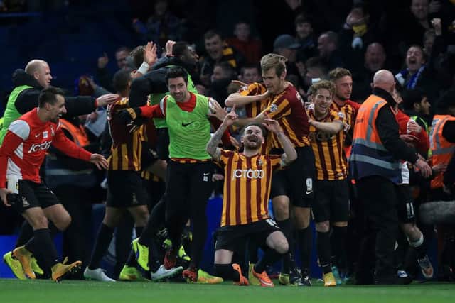 Bradford City's Mark Yeates (front) celebrates with his delirious team-mates after scoring his side's fourth goal against Chelsea at Stamford Bridge.