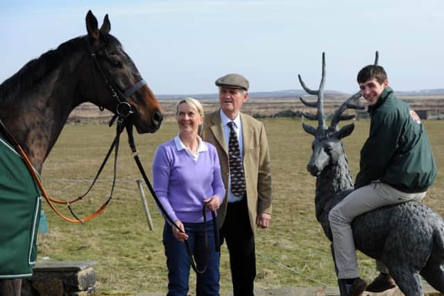 Grand National winning jockey Ryan Mania rides an ornamental stag at Craiglands Farm, High Eldwick, as the winning horse Aurora's Encore looks on. The horse is stabled at the farm which is home to the horse's trainer Sue Smith and her husband, former champion show jumper Harvey Smith, centre