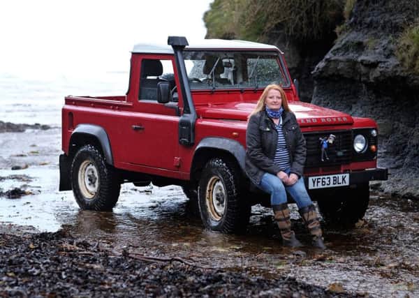 Peta Nugent with her Defender 90 pick up which provides her with a way in and out of the Boggle Hole Youth Hostel on the Yorkshire Coast. Â©  Tony Bartholomew / Turnstone Media