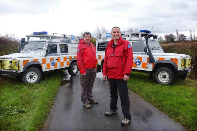 Scarborough and Ryedale Mountain Rescue Team members David Edwards and Ian Hugill with their Defender 110's. Â©  Tony Bartholomew / Turnstone Media