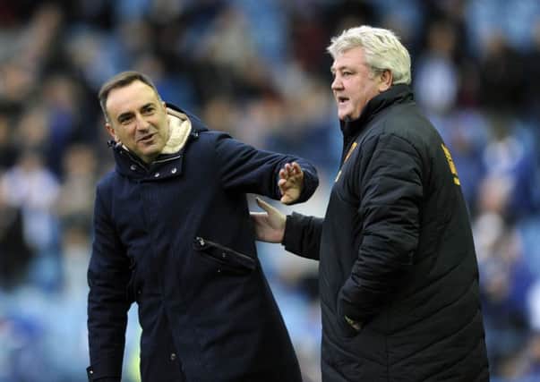 CUP JOY: Sheffield Wednesday boss Carlos Carvalhal, left, and Hull City counterpart Steve Bruce are both hoping to avoid an FA Cup shock today.