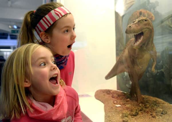 Sisters, Alice, aged five, and Florence  Slezak, seven, from York, getting a close up view of a T Rex at the Yorkshire Museum as part of the York Residents Festival. (GL1008/78b)