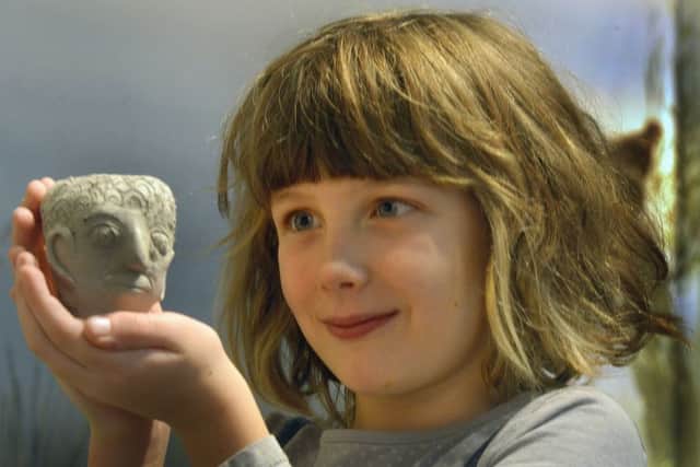 Mila Scarborough, aged seven, from York, with a Roman face pot made at a workshop run by York College at The Yorkshire Museum. (GL1008/78c)