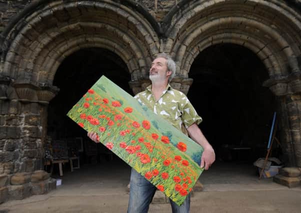 Artist David Starling  pictured with one of his paintings at Kirkstall Abbey during the 2015 Kirkstall Art Trail.