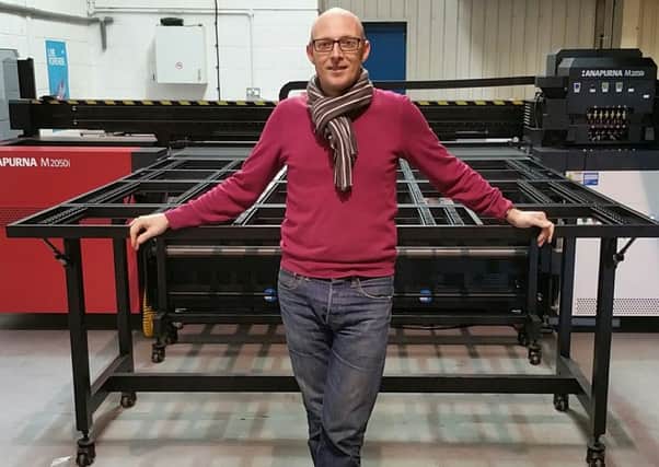 BIG PRINT: Dan Brook, director of Spin Print, stood in front of the new large format printing press.