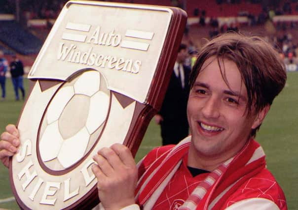 Rotherham's Nigel Jemson celebrates with the Auto Windscreen Shield after his two goals decided the Wembley final against Shrewsbury Town.