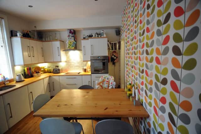 l The kitchen with Orla Kiely wallpaper and cupboards painted in Annie Sloan