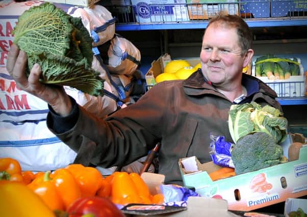 Famer and fruit and veg wholesaler Phil Train inspects the produce in the warehouse.   Pic: Richard Ponter 160423g