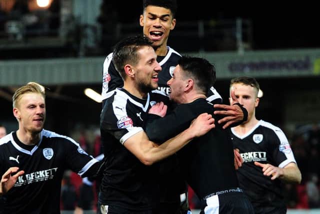WEMBLEY HERE WE COME:  Barnsley players mob Adam Hamill, right, after he scored the decisive penalty in a shoot-out against Fleetwood Town to reach the final of the Johnstones Paint Trophy. Picture: Jonathan Gawthorpe.