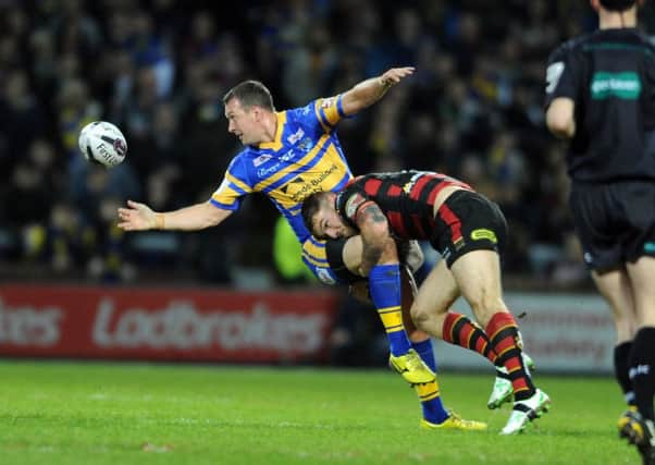BAD START: Danny McGuire offloads as Wolves Daryl Clark hits.  Picture: Tony Johnson