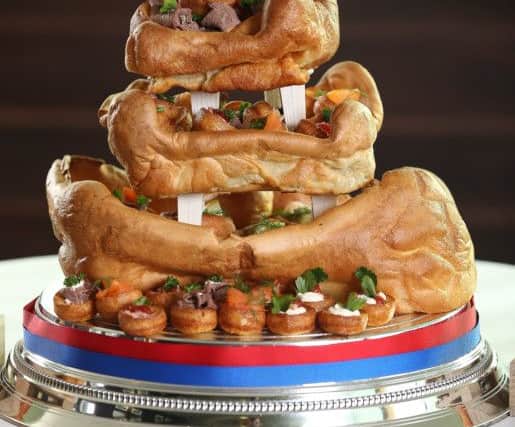 Adam Nicholson and Becca Piwinksi of Beverley, East Yorkshire have won the ultimate northern wedding cake - made from YORKSHIRE PUDDINGS. Picture: Ross Parry Agency