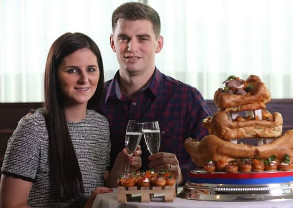 Adam Nicholson and Becca Piwinksi of Beverley, East Yorkshire have won the ultimate northern wedding cake - made from YORKSHIRE PUDDINGS. Picture: Ross Parry Agency