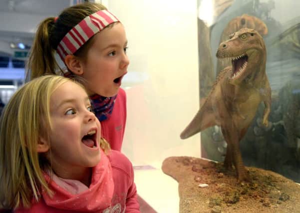 Sisters  Alice 5 and Florence 7  Slezak from York, gets a close up view of a T Rex at the Yorkshire Museum
