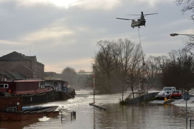 An Army Chinook helicopter airlifts equipment needed to repair the Foss Barrier on the River Foss in York. Hundreds of flood defence schemes have been left requiring repair after the UK was battered by record-breaking rain and storms, the Environment Agency said. PRESS ASSOCIATION Photo. Issue date: Tuesday February 2, 2016. More than 20,000 properties were flooded as storms Desmond and Eva swept across the country and December became the wettest month on record, the latest update reveals. The last month of 2015 saw 14 rivers across the north recording their highest ever flows, and 194 Environment Agency gauges registered their highest river levels on record. See PA story ENVIRONMENT Floods. Photo credit should read: Anna Gowthorpe/PA Wire