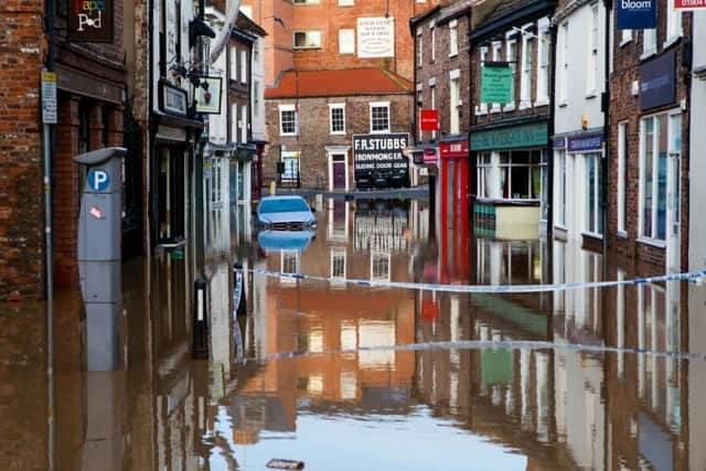 Walmgate, a popular shopping street in York is cut off as it has flooded for the first time in years. 3500 properties are at risk in the city as the water levels in the River Foss and River Ouse continue to rise. December 27 2015.
