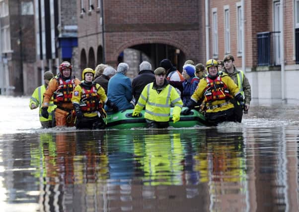 Members of the Army and rescue teams help evacuate people from flooded properties after they became trapped by rising floodwater when the River Ouse bursts its banks in York city centre. PRESS ASSOCIATION Photo. Picture date: Sunday December 27, 2015. Hundreds more people are being evacuated as flooding continues to cause misery across the north of England. Prime Minister David Cameron will chair a conference call of the Government's emergency Cobra committee as the crisis deepens. Police advised between 300 and 400 people to evacuate in York by the River Ouse and River Foss, with hundreds more believed to be at risk. See PA story WEATHER Floods. Photo credit should read: John Giles/PA Wire