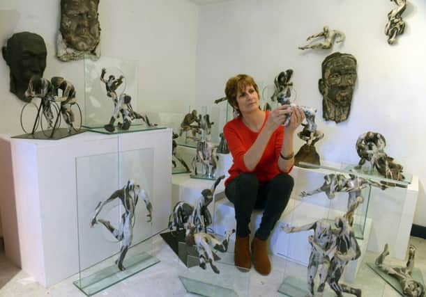 Mandy Long from Leeds  surrounded by some of her sculptures