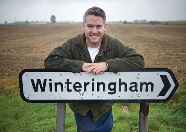 Colin McGurran with the Winteringham Village sign