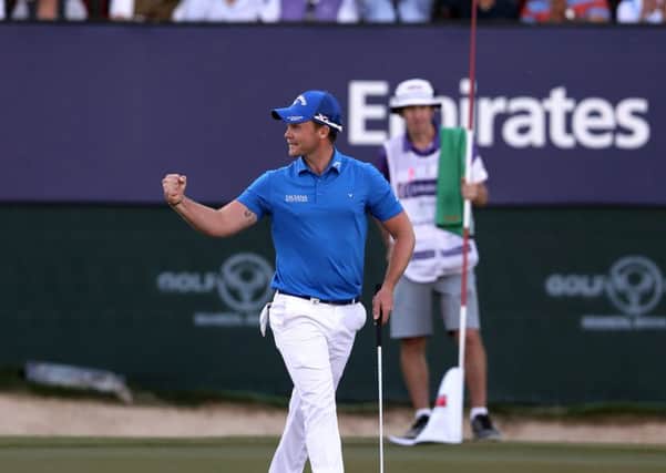 Danny Willett of England celebrates after he won the Dubai Desert Classic golf tournament in Dubai. (AP Photo/Kamran Jebreili)