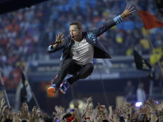 Coldplay singer Chris Martin performs during halftime of the NFL Super Bowl 50 football game Sunday, Feb. 7, 2016, in Santa Clara, Calif. (AP Photo/Marcio Jose Sanchez)