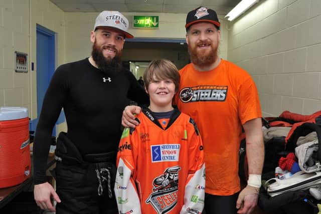 Steelers' fan Travis Wainwright gets to meet his on-ice Jason Hewitt, left and Zack Fitzgerald.