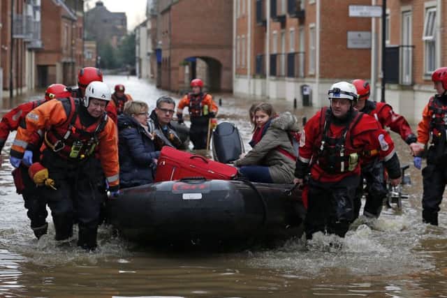 A family is rescued from the centre of York by boat.