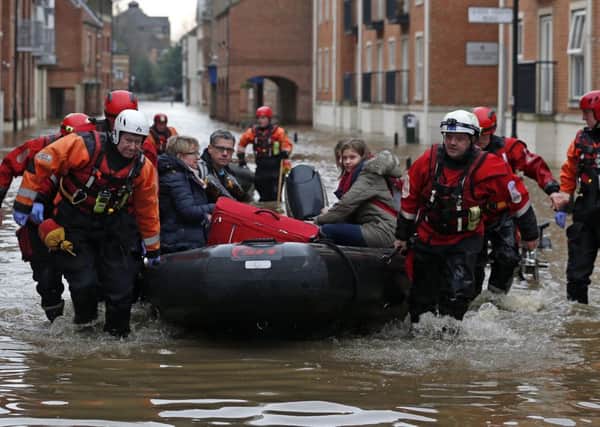 A family is rescued from the centre of York by boat.