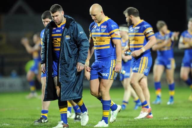 Leeds Rhinos' Brett Delaney and Carl Ablett show their disappointment at losing the opening game of the season against Warrington.  Picture: Tony Johnson.
