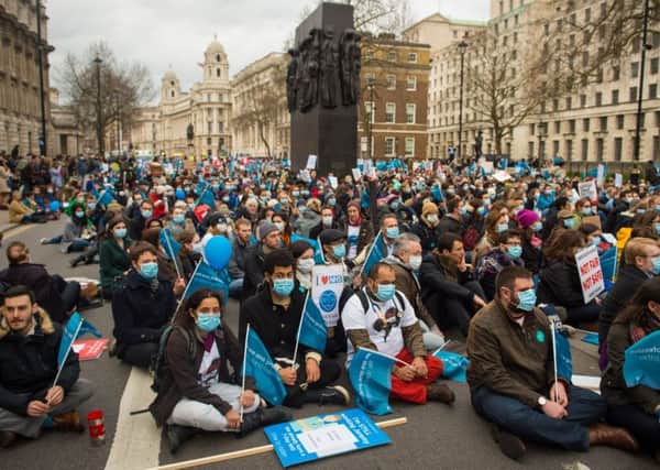 Junior doctors and their supporters stage sit-down protest outside Downing Street.