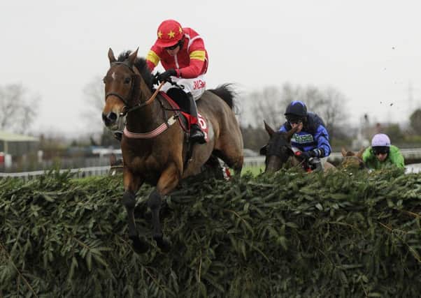 ONE TO WATCH: Highland Lodge and Henry Brooke jump the final fence as they win the Betfred Becher Chase at Aintree in December. Picture: PA