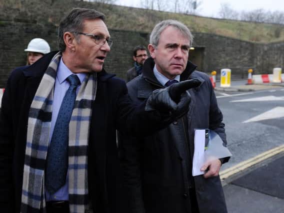 Calder Valley MP Craig Whittaker and Yorkshire flood envoy Robert Goodwill MP survey damage at Elland Bridge caused by the Boxing Day floods. Pictured in January 2016 by Bruce Rollinson.
