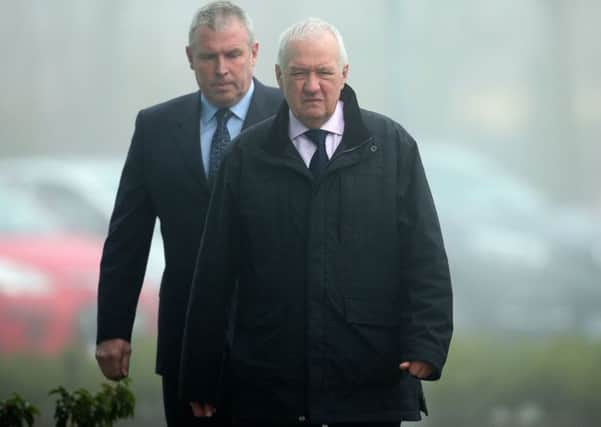 Former chief superintendent David Duckenfield (front) is escorted in to the Hillsborough Inquest in Warrington last March