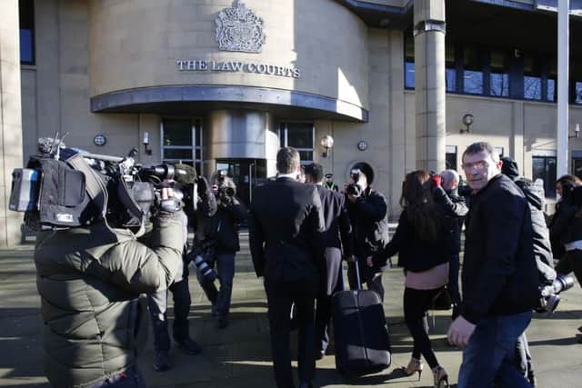 England footballer Adam Johnson, 28, surrounded by media as he arrives at Bradford Crown Court