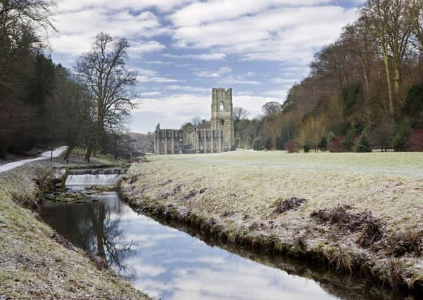 A view along the River Skell in winter towards Fountains Abbey, North Yorkshire.